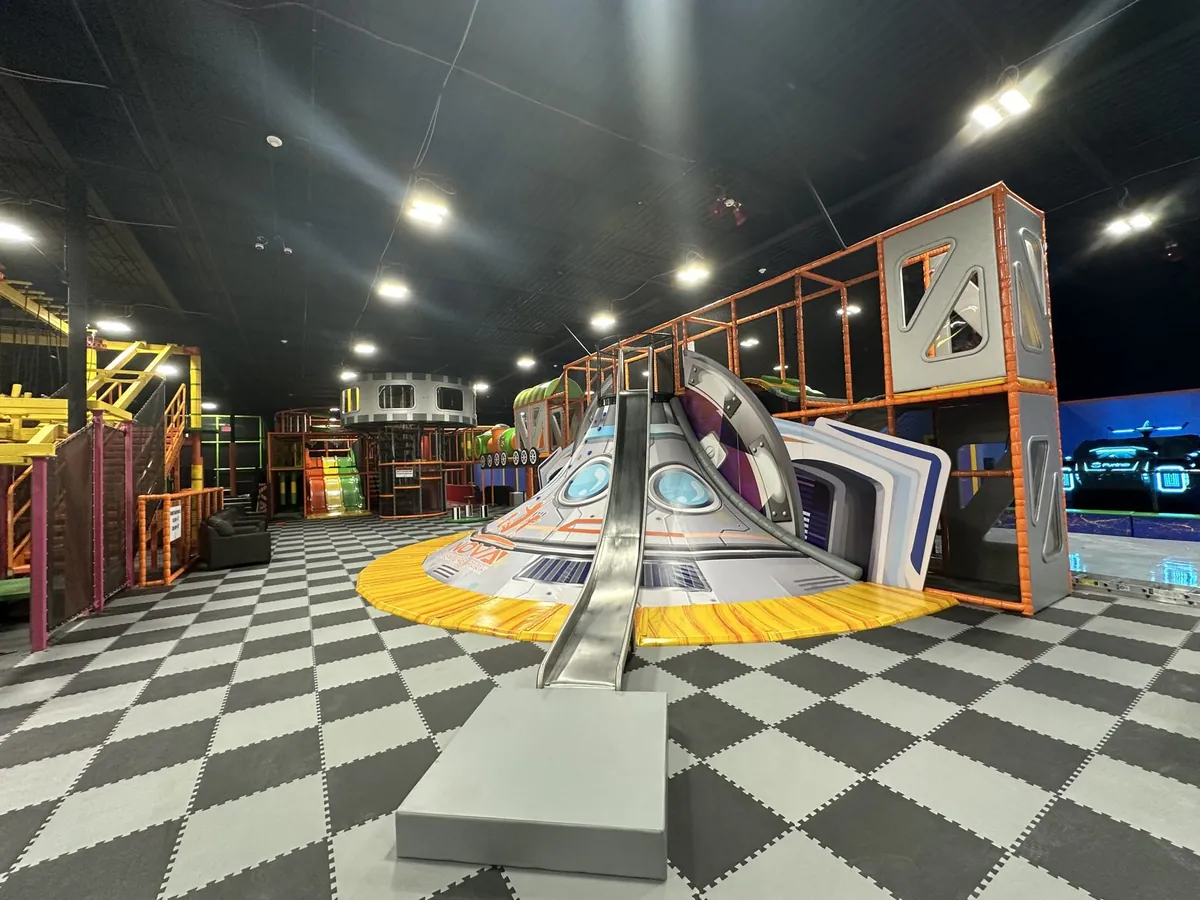 Indoor playground with a spaceship slide at Nova Adventure Park